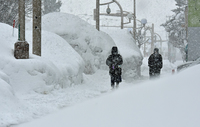 People walk in the snow in the city of Aomori on Thursday.