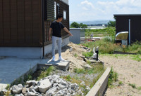 A resident points to a boundary of his house affected by liquefaction from the 2024 Noto Peninsula earthquake in the town of Uchinada, Ishikawa Prefecture, on Wednesday.