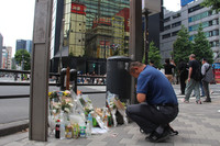 A man offers a prayer in Tokyo's Akihabara district on Sunday, which marks the 17th anniversary of the June 8, 2008, indiscriminate attack that killed seven people and injured 10 others.