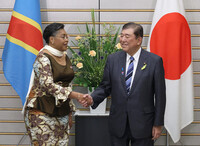 Japanese Prime Minister Shigeru Ishiba (right) shakes hands with his Congolese counterpart, Judith Suminwa, at the Japanese prime minister's office in Tokyo on Tuesday.