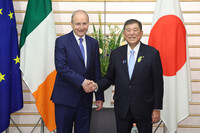 Prime Minister Shigeru Ishiba (right) and his Irish counterpart, Micheal Martin, shake hands in Tokyo on Wednesday.