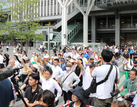 Voters listening to a stump speech ahead of Sunday's House of Councillors election in Fukuoka on Monday