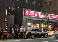 Police investigators examine an area near the scene where multiple passersby were injured in a knifing spree in Mito, Ibaraki Prefecture, on Monday.